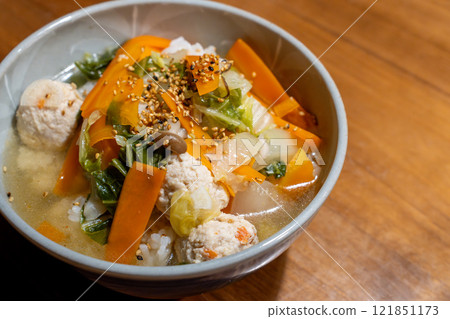 Porridge with meatballs and plenty of vegetables 121851173