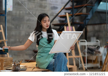 Lifestyle, people artist painting on canvas in the home studio. 121851221