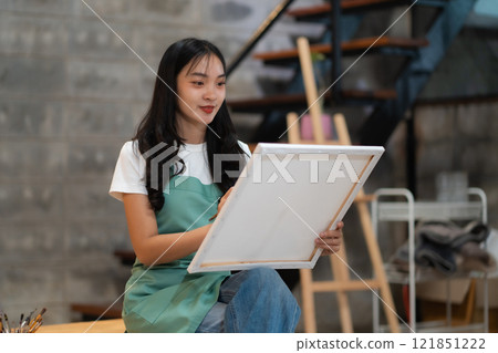 Lifestyle, people artist painting on canvas in the home studio. Lifestyle, people artist painting on canvas in the home studio. 121851222