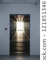 Modern corridor with server racks and bright window at the end. Perspective interior view of a technology facility. Data center infrastructure. Vertical photo for design and print 121851346