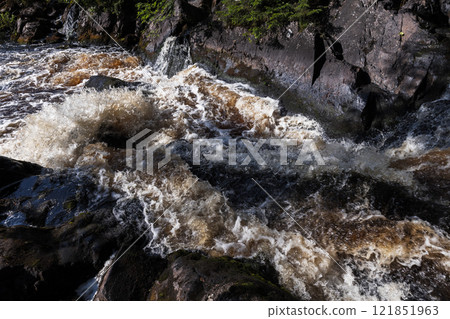 Waterfalls of Ruskeala, coastal rocks and fast water on a summer day Waterfalls of Ruskeala, coastal rocks and fast water on a summer day 121851963