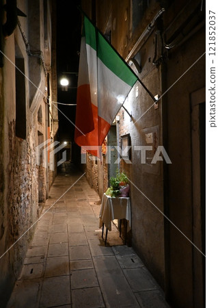 Venice alley with italian flag 121852037