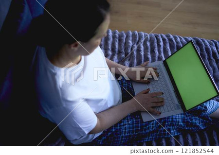 a senior woman working from home on laptop, green screen, chromakey 121852544