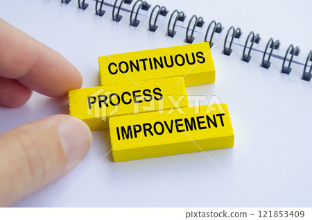Continuous Process Improvement text on yellow wooden blocks. Continuous Process Improvement text on yellow wooden blocks. 121853409
