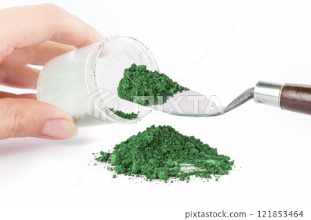 Cobalt Green, Green Powder Spills From a Jar Onto a Clean Surface With a Scoop Nearby Ready for Use Cobalt Green, Green Powder Spills From a Jar Onto a Clean Surface With a Scoop Nearby Ready for Use 121853464