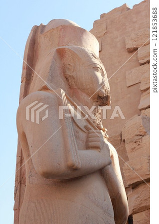 Partly damaged pharaoh statue in Luxor, Egypt. Ancient travel destination in North Africa. Partly damaged pharaoh statue in Luxor, Egypt. Ancient travel destination in North Africa. 121853688