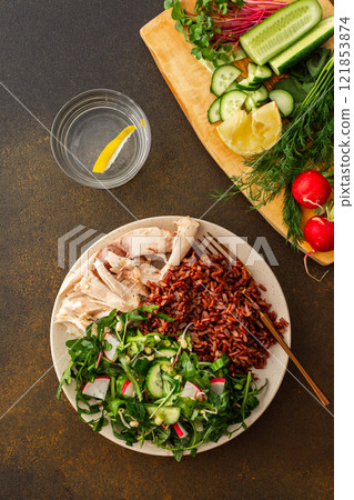 Chicken breast with red rice and salad mix with seasonal organic vegetables 121853874
