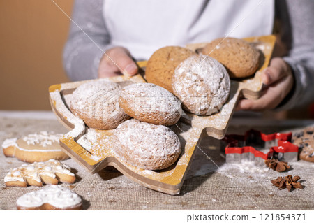 Freshly baked gingerbread cookies served on a decorative tray with festive details. Freshly baked gingerbread cookies served on a decorative tray with festive details. 121854371
