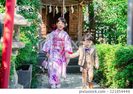 A 5-year-old girl visits a shrine for the Shichigosan festival with her younger brother A 5-year-old girl visits a shrine for the Shichigosan festival with her younger brother 121854449