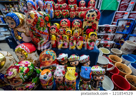 Budapest,Hungary. August 29,2022. Nice shot with a display of Russian dolls at the large central market. It is one of the most popular souvenirs, numerous varieties and colors. Budapest,Hungary. August 29,2022. Nice shot with a display of Russian dolls at the large central market. It is one of the most popular souvenirs, numerous varieties and colors. 121854529