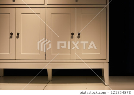 White kitchen cabinets in dim light 121854878
