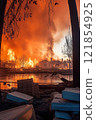 Intense wildfire consuming a residential neighborhood. Concept of natural disasters, devastation, and the urgent need for environmental action. 121854925