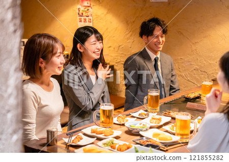 A female office worker laughing out loud at a drinking party 121855282