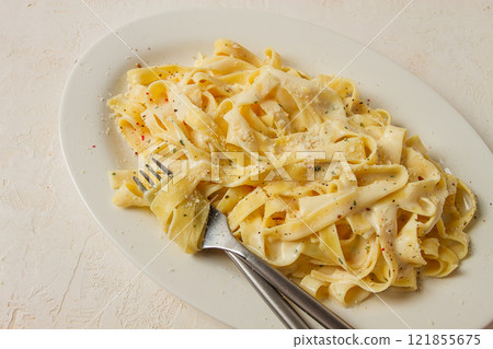 Fettuccine, tagliatelle, in creamy garlic sauce, Italian traditional cuisine, pasta carbonaro, 121855675