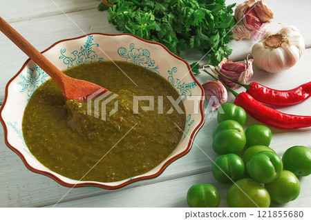 Tkemali sauce, traditional Georgian cuisine, green cherry plum, on a white wooden table, close-up, rustic, food background, no people, selective focus, Tkemali sauce, traditional Georgian cuisine, green cherry plum, on a white wooden table, close-up, rustic, food background, no people, selective focus, 121855680