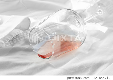 Glass, with pink wine, spilled on a white shirt, close-up, selective focus, no people, concept, top view, 121855719