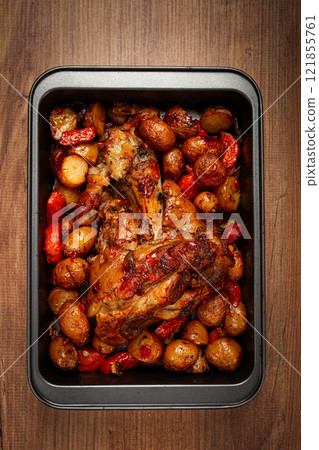 Pork knuckle, baked with vegetables, new potatoes , on a baking sheet, homemade, no people, Pork knuckle, baked with vegetables, new potatoes , on a baking sheet, homemade, no people, 121855761