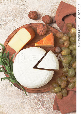 Georgian cheese, Imeretian and smoked suluguni, grapes, nuts, on a cutting board, Georgian cuisine, no people, 121855887