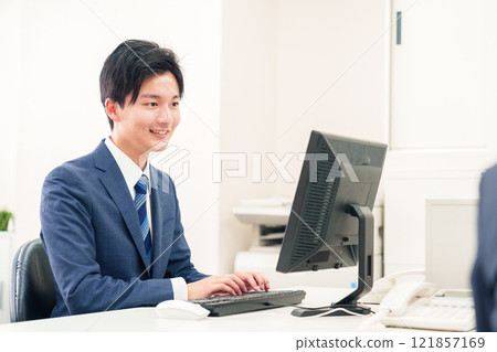 在辦公室辦公桌前工作的年輕人 121857169