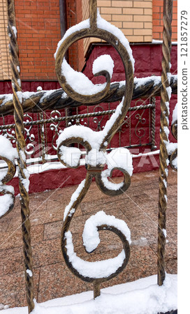 Snow on twisted lattice of fence. The patterns of winter. Abstraction Snow on twisted lattice of fence. The patterns of winter. Abstraction 121857279