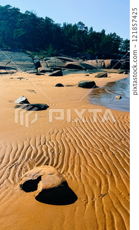 Ribbed sand and rocks on the shore of the White Sea Ribbed sand and rocks on the shore of the White Sea 121857425