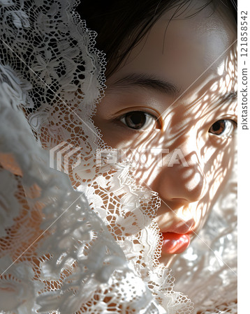 Asian woman reflected in the shadows of lace 121858542