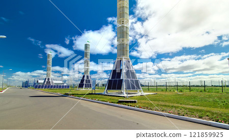Solar Panel towers on solar plant with High Voltage Tower in Background timelapse hyperlapse 121859925