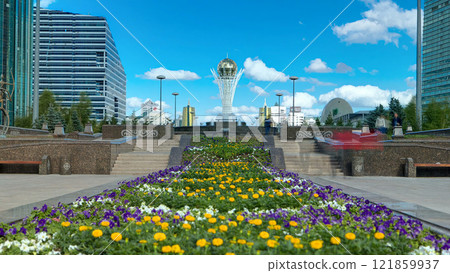 Flowers on Nurzhol Boulevard with Baiterek on background timelapse hyperlapse 121859937