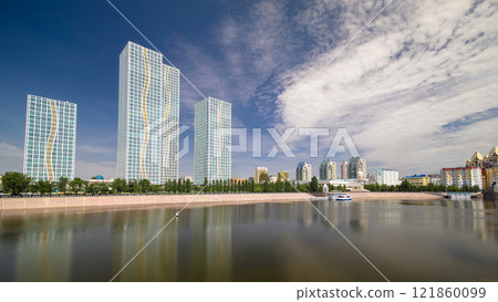 Ishim River with modern towers of residential complex timelapse hyperlapse in Astana 121860099