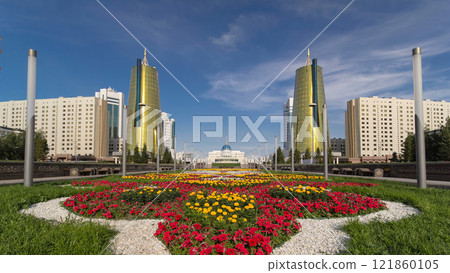 A square in front of Ak Orda with Altyn Orda business center timelapse hyperlapse in the foreground. 121860105
