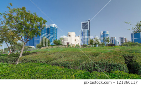 Corniche boulevard beach park along the coastline in Abu Dhabi timelapse hyperlapse with skyscrapers on background. Corniche boulevard beach park along the coastline in Abu Dhabi timelapse hyperlapse with skyscrapers on background. 121860117