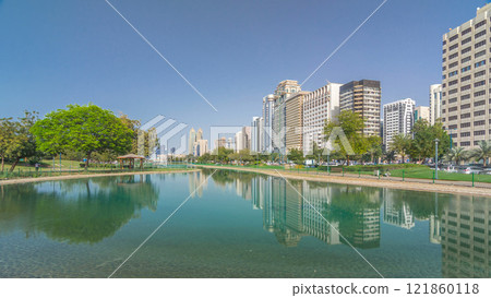 Corniche boulevard beach park along the coastline in Abu Dhabi timelapse hyperlapse with skyscrapers on background. Corniche boulevard beach park along the coastline in Abu Dhabi timelapse hyperlapse with skyscrapers on background. 121860118