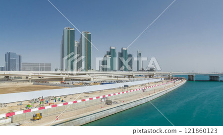 Modern buildings in Abu Dhabi skyline timelapse hyperlapse with waterfront. 121860123
