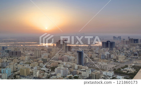 Sunrise with cityscape of Ajman from rooftop aerial timelapse. Sunrise with cityscape of Ajman from rooftop aerial timelapse. 121860173