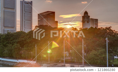 Sunset over Singapore skyscrapers skyline with white Anderson Bridge near esplanade park timelapse. Sunset over Singapore skyscrapers skyline with white Anderson Bridge near esplanade park timelapse. 121860280