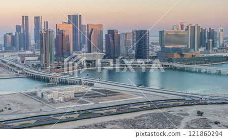 Aerial skyline of Abu Dhabi city centre from above day to night timelapse 121860294