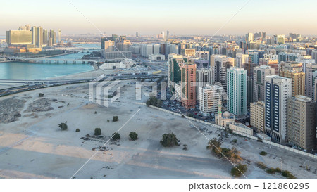 Aerial skyline of Abu Dhabi city centre from above day to night timelapse Aerial skyline of Abu Dhabi city centre from above day to night timelapse 121860295