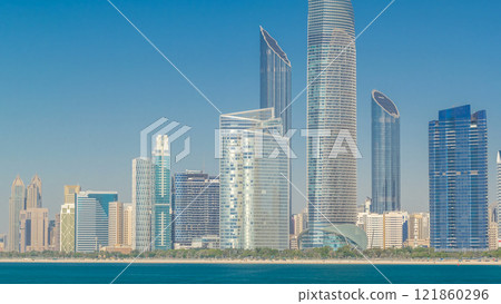 View of high skyscrapers on a corniche in Abu Dhabi stretching alongside the business center timelapse hyperlapse. View of high skyscrapers on a corniche in Abu Dhabi stretching alongside the business center timelapse hyperlapse. 121860296