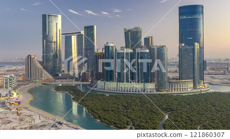 Buildings on Al Reem island in Abu Dhabi day to night timelapse from above. Buildings on Al Reem island in Abu Dhabi day to night timelapse from above. 121860307