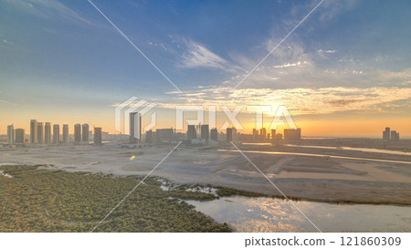 Buildings on Al Reem island in Abu Dhabi at sunset timelapse from above. Buildings on Al Reem island in Abu Dhabi at sunset timelapse from above. 121860309