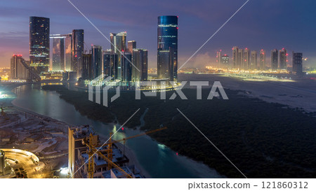 Buildings on Al Reem island in Abu Dhabi timelapse from above. 121860312