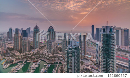 Aerial top view of sunrise in Dubai Marina timelapse. Modern towers and traffic on the road Aerial top view of sunrise in Dubai Marina timelapse. Modern towers and traffic on the road 121860337