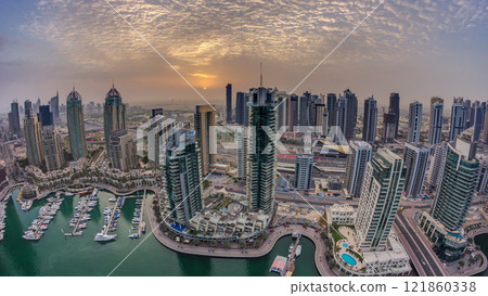 Aerial top view of sunrise in Dubai Marina timelapse. Modern towers and traffic on the road Aerial top view of sunrise in Dubai Marina timelapse. Modern towers and traffic on the road 121860338