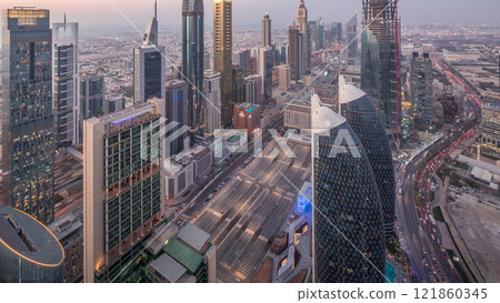 Skyline of the buildings of Sheikh Zayed Road and DIFC aerial day to night timelapse in Dubai, UAE. 121860345