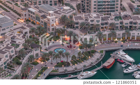 Dubai Marina Walk with fountain and palms aerial Top View night to day timelapse Dubai Marina Walk with fountain and palms aerial Top View night to day timelapse 121860351