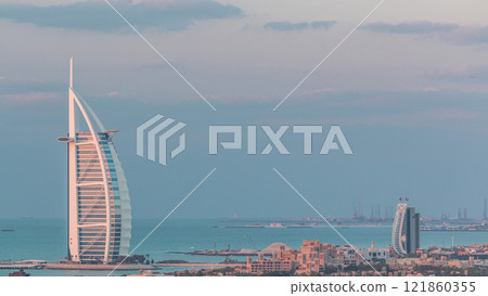 Aerial view of Burj Al Arab hotel from Internet city day to night timelapse. 121860355