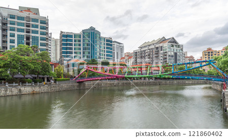 Alkaff Bridge on the Singapore River at Robertson Quay with dark gray clouds timelapse hyperlapse 121860402