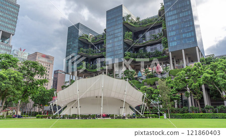 Hong Lim Park timelapse hyperlapse covered by some bushes and a large trees with terraced gardens on a background 121860403