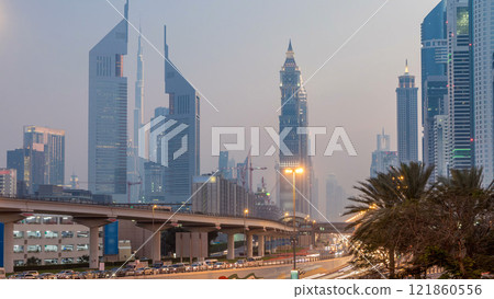 Traffic on intersection and bridge at the Sheikh Zayed Road day to night timelapse 121860556