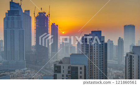 Foggy morning sunrise in downtown of Dubai timelapse. Foggy morning sunrise in downtown of Dubai timelapse. 121860561